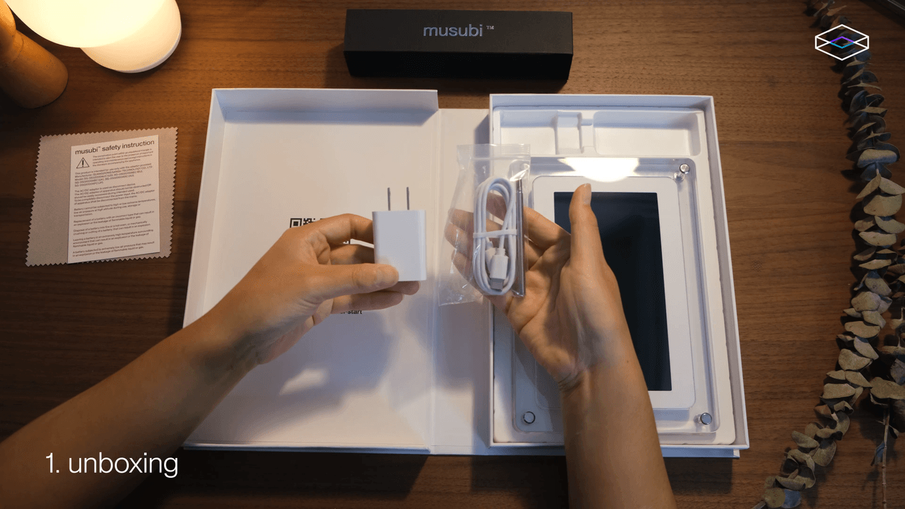 The musubi display, power adapter, and USB-C cable inside the open package